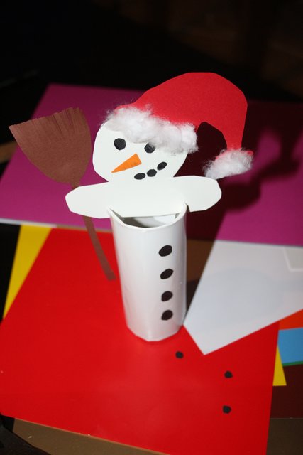 Dann nur noch den Körper in die Schlitze einsetzen und die Figur nach Belieben dekorieren. Wir haben uns für einen Schneemann mit Weihnachtsmütze und Besen entschieden.