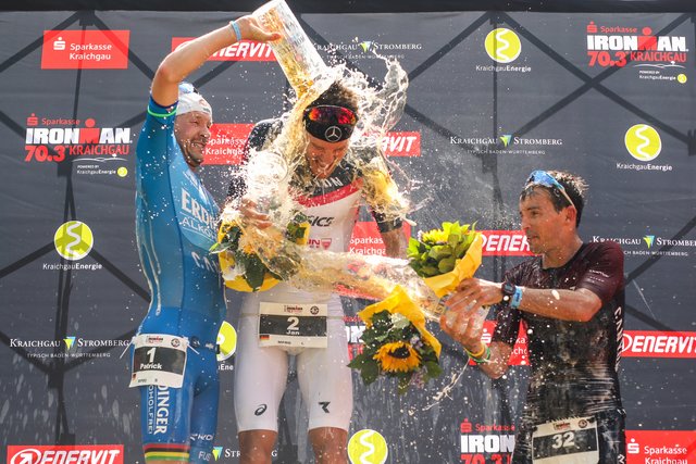 KRAICHGAU, GERMANY - JUNE 03: Jan Frodeno (C), Patrick Lange (L) and Nicholas Kastelein spray with beer after winning the Sparkasse IRONMAN 70.3 Kraichgau powered by KraichgauEnergie on June 3, 2018 in Kraichgau, Germany.  (Photo by Joern Pollex/Getty Images for IRONMAN)