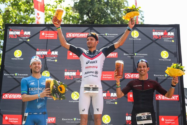 KRAICHGAU, GERMANY - JUNE 03:  Jan Frodeno (C), Patrick Lange (L) and Nicholas Kastelein celebrate after winning the Sparkasse IRONMAN 70.3 Kraichgau powered by KraichgauEnergie on June 3, 2018 in Kraichgau, Germany.  (Photo by Joern Pollex/Getty Images for IRONMAN)